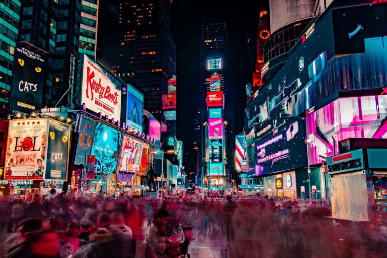 A street with neon promotion signs