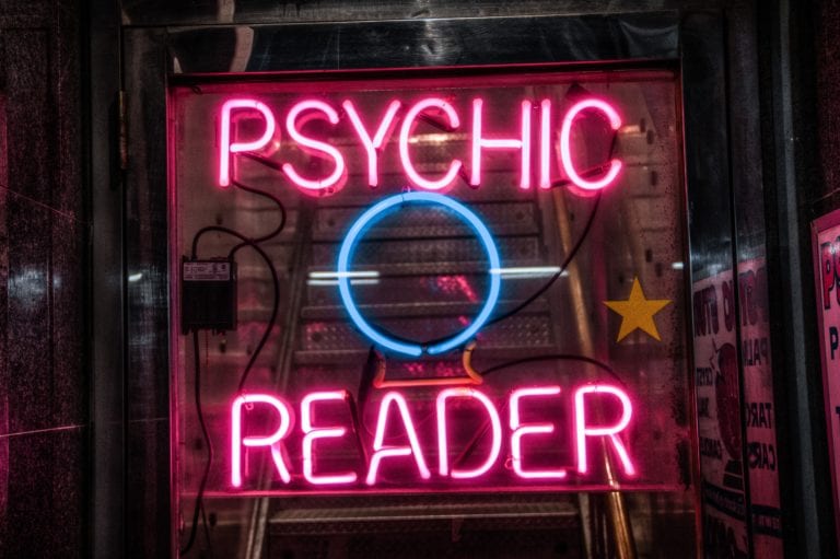 Neon sign saying "Psychic Reader"